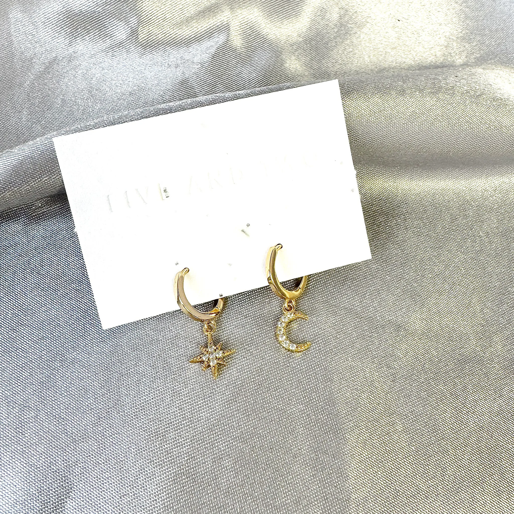 Five and Two Chloe Huggie Hoop Star Moon Charm Earrings in 14k Gold Plated